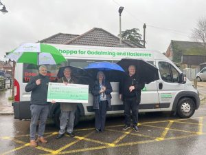 Image; the Mayor of Haslemere, Cllr Jerome Davidson and Chair of Grants, Cllr Jacquie Keen hand over cheque for £7500 to Richard Davies (General Manager) and Andy Taylor (Transport Manager)